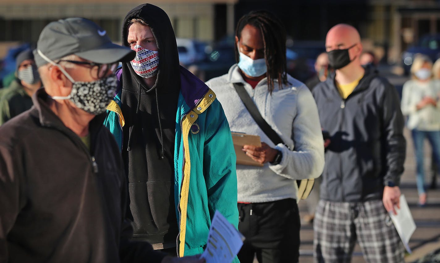 Masked voters lined up in Minneapolis on the first day of voting in September.