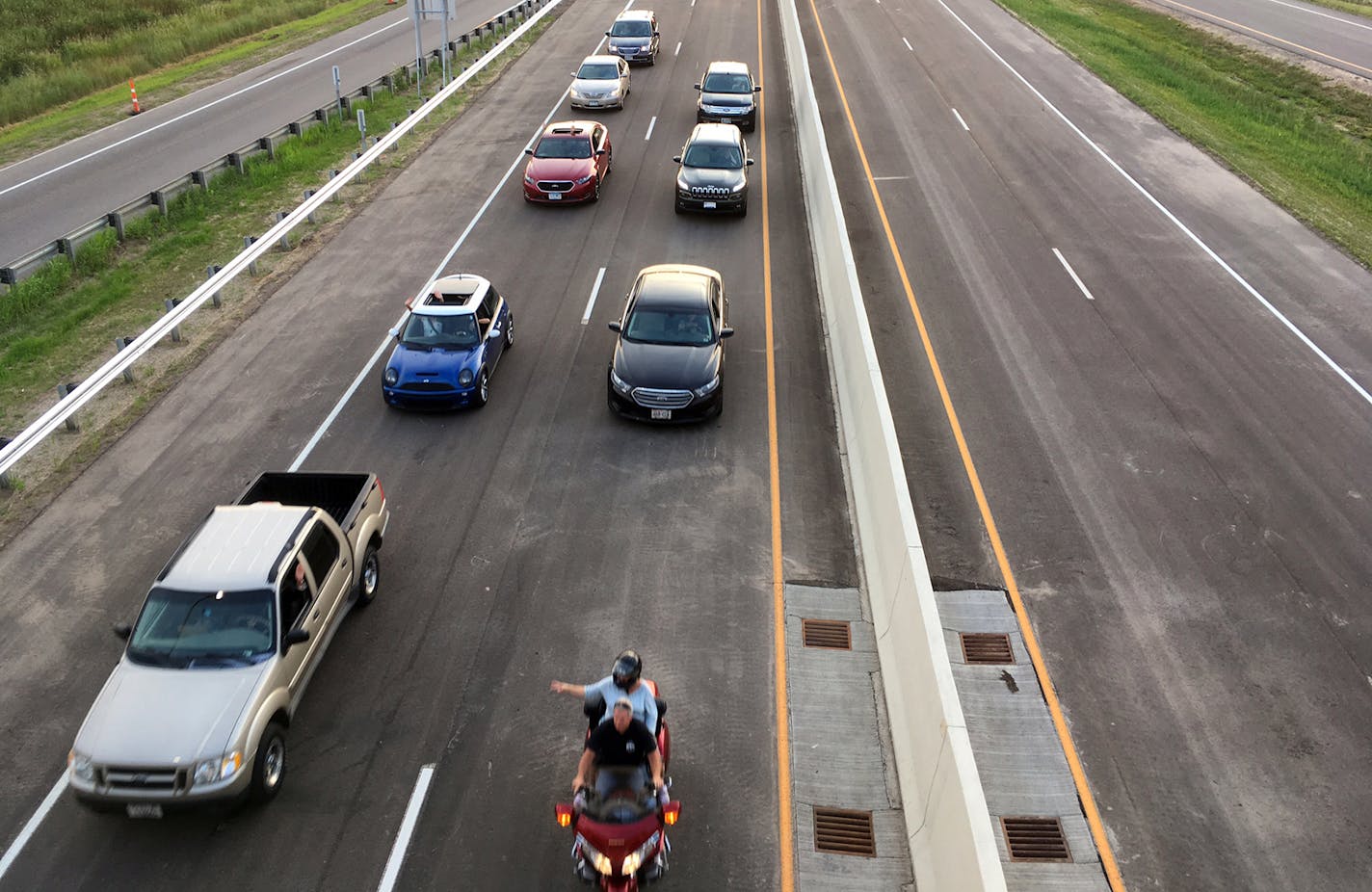 The first cars to cross the St. Croix River bridge left Oak Park Heights on their way across the milelong span in early August. The old Stillwater Lift Bridge closed almost simultaneously.