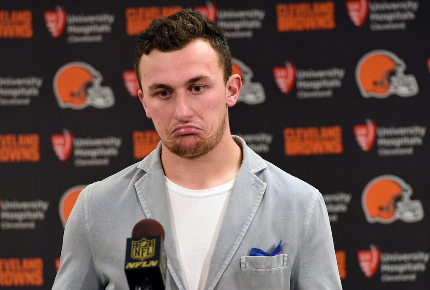 FILE - In this Nov. 15, 2015, file photo, Cleveland Browns quarterback Johnny Manziel attends a post-game news conference after a 30-9 loss to the Pittsburgh Steelers, in Pittsburgh. The Browns have released troublesome quarterback Johnny Manziel. The team cut ties on Friday, March 11, 2016, with the 2012 Heisman Trophy winner after two disappointing, drama-filled seasons. Manziel faces an uncertain future in the NFL and potential criminal charges in Texas following a domestic violence incident. (AP Photo/Don Wright, File)