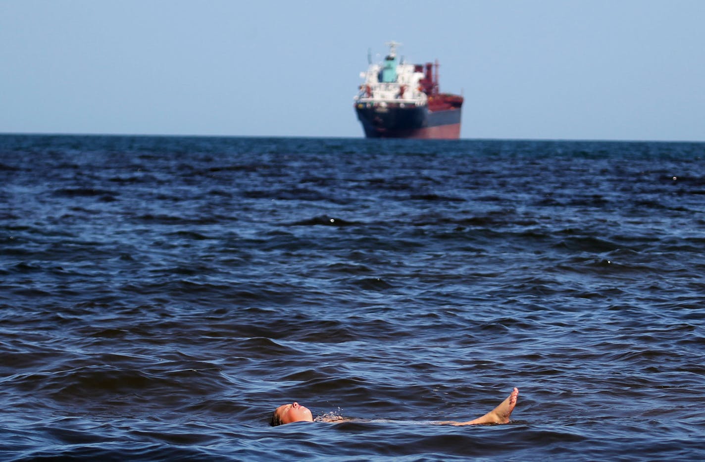 DAVID JOLES &#xa5; djoles@startribune.com - Duluth, MN - Aug. 27, 2010- Usually Lake Superior warms to its highest temps in mid-August, but this year it came a month early. But in typical Superior fashion, it didn't last. Historic high winds blew in, driving surface water temps back down. Still, it's a strange year, and scientists are going to keep measuring into next month to see what happens. In this photo:] Swimmers and beach goers were out in full force at Park Point Beach where Tyler Kern,