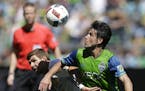 Seattle Sounders midfielder Nicolas Lodeiro, right, battles for the ball with Los Angeles Galaxy forward Steven Gerrard, left, in the second half of a