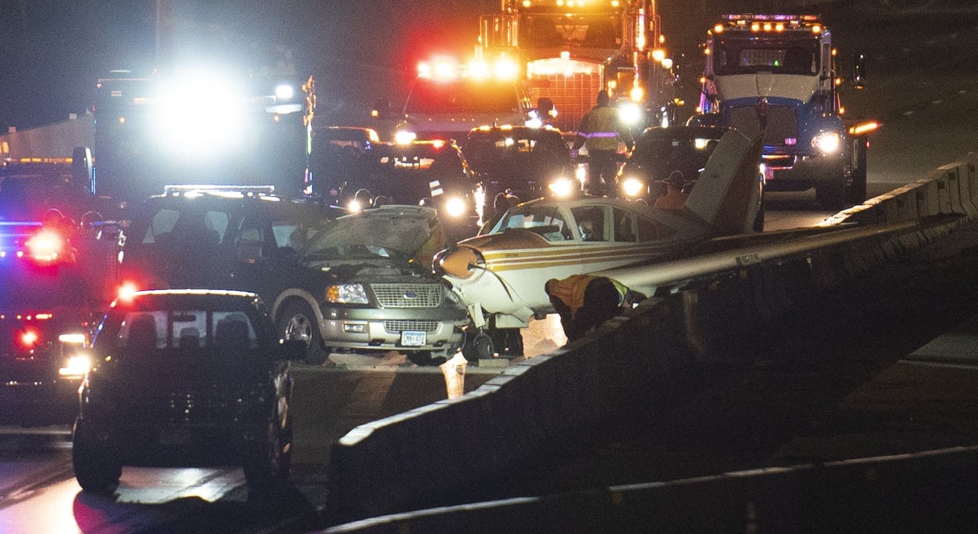 A single-engine plane came to rest atop a concrete barrier on northbound Interstate 35W after hitting an SUV while making an emergency landing on Wednesday night.