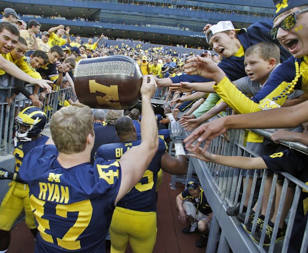 Minnesota Gophers vs. Michigan football. Michigan won 42-13. Michigan fans reached out to touch the Little Brown Jug as it was carried off the field b