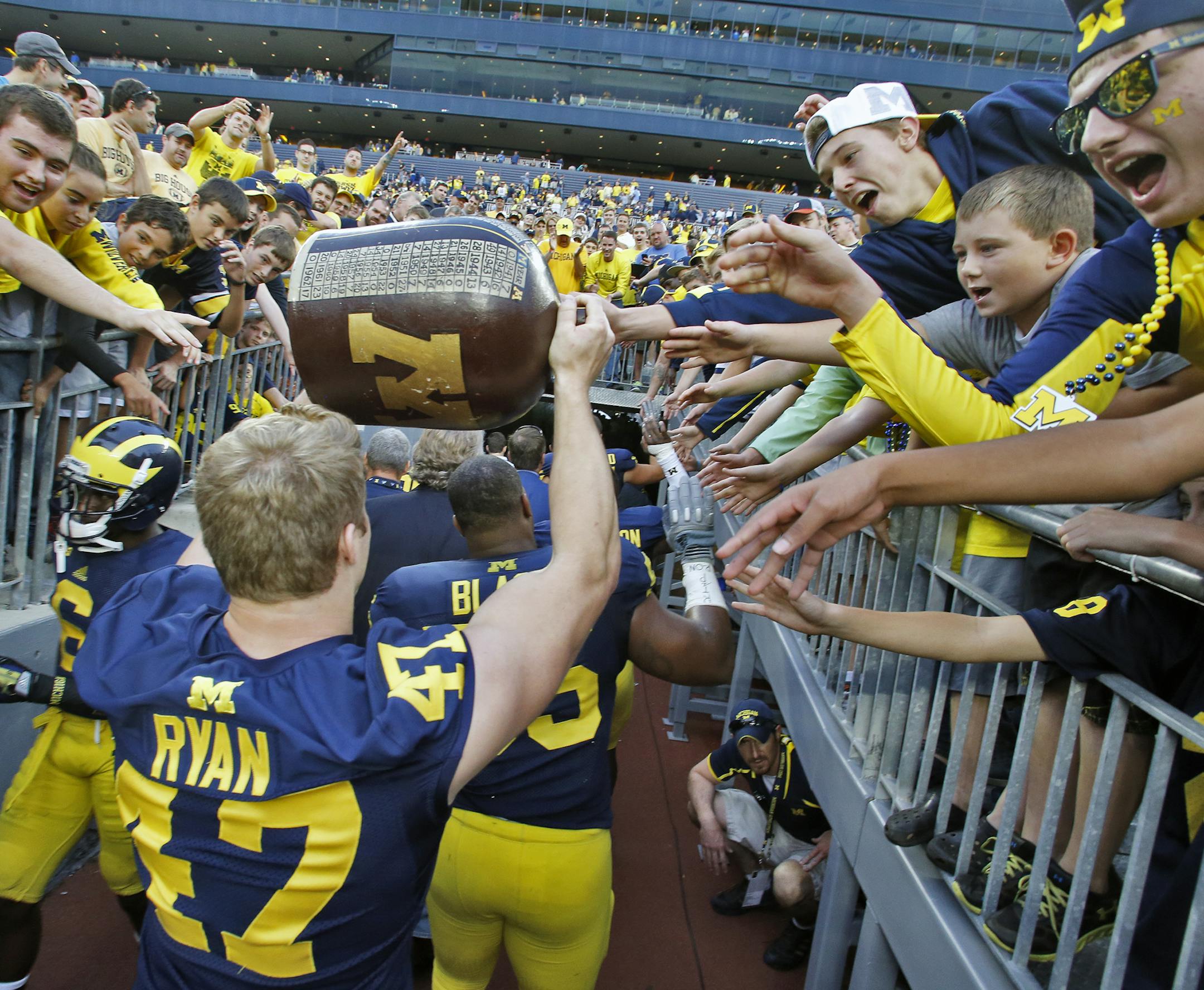 Minnesota Gophers vs. Michigan football. Michigan won 42-13. Michigan fans reached out to touch the Little Brown Jug as it was carried off the field by Michigan players at the end of the game. (MARLIN LEVISON/STARTRIBUNE(mlevison@startribune.com)