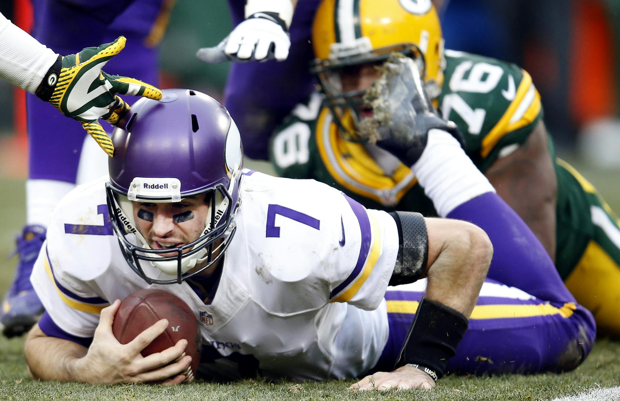 Vikings quarterback Christian Ponder (7) was sacked by Mike Daniels (76) in overtime. ] CARLOS GONZALEZ cgonzalez@startribune.com - November 24, 2013, Lambeau Field, Green Bay, WI, NFL, Minnesota Vikings vs. Green Bay Packers