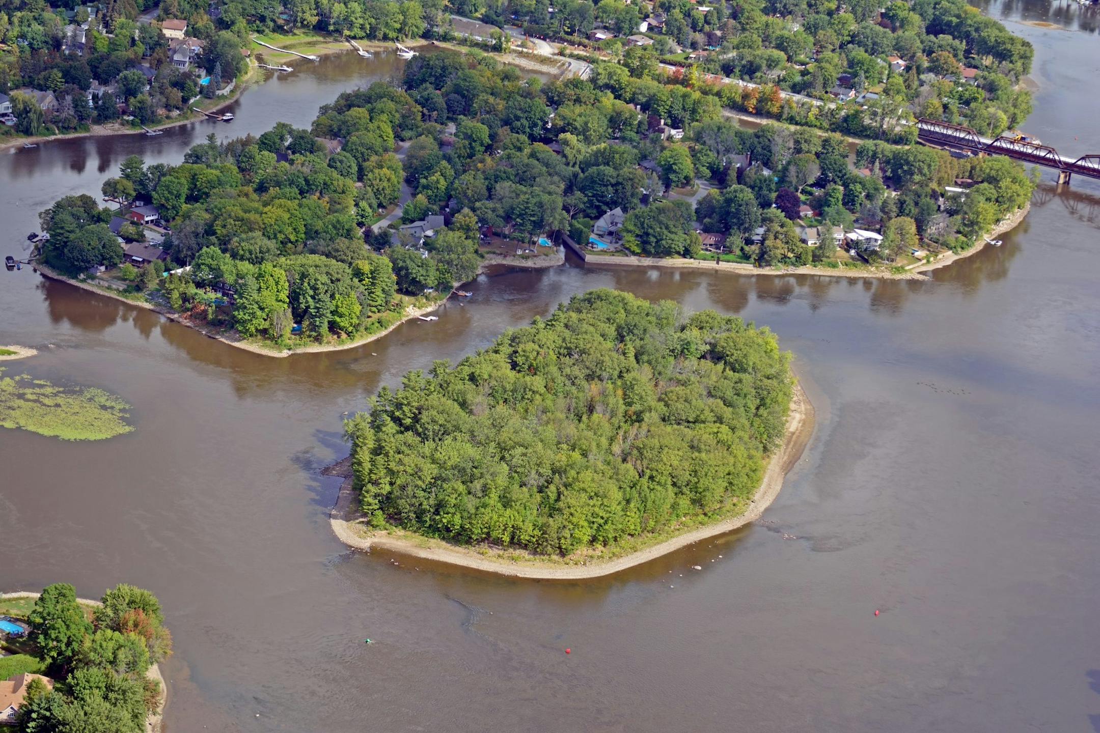 'l Ronde, the oval island at center, comprises seven acres and sits in the Prairies River, directly across from an island called 'le Verte. MUST CREDIT: Photo by Claude Ducha'ne