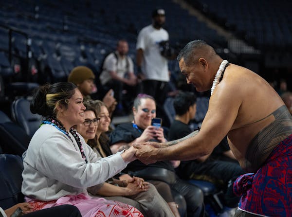 Alissa Pili is urged by former Vikings player and fellow Samoan Esera Tuaolo to join him in a traditional Samoan dance during the welcome event for Pi