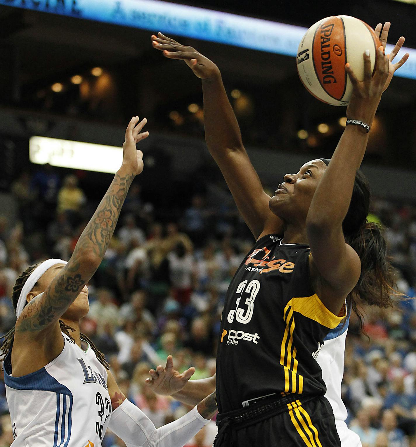 Tulsa Shock forward Tiffany Jackson-Jones, right, goes to the basket against guard Minnesota Lynx Seimone Augustus, left, in the first half of a WNBA basketball game on Friday, Aug. 16, 2013, in Minneapolis. (AP Photo/Stacy Bengs)