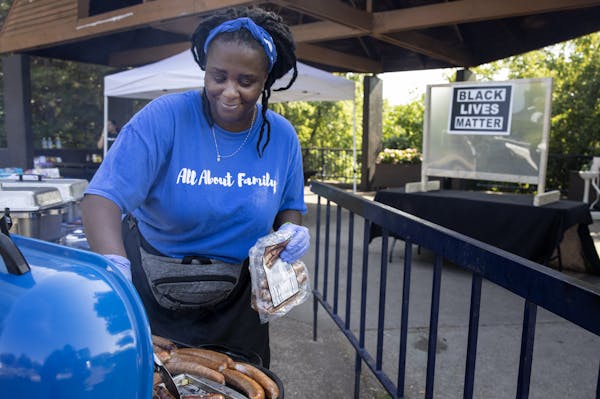 Tasheka James, owner of Chubby's Catering prepared food at the Black Entrepreneur State Fair at Father Hennepin Bluff Park in Minneapolis. ] CARLOS GO