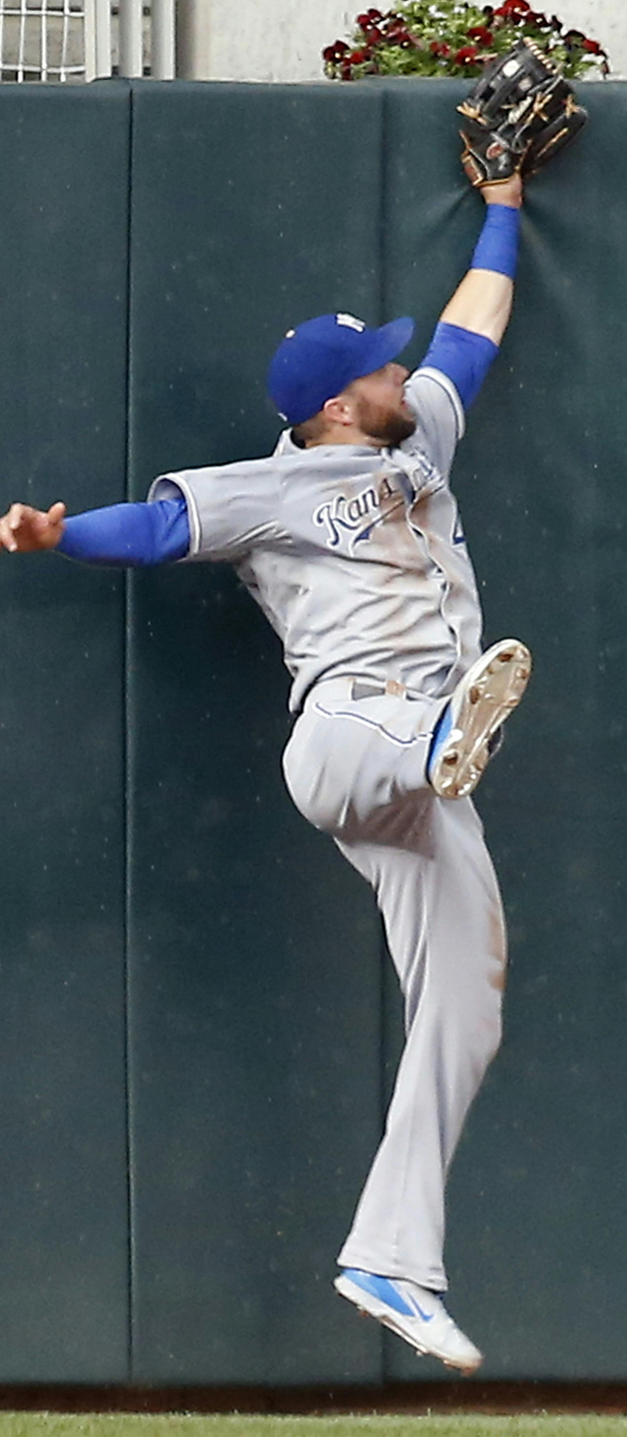 Kansas City Royals left fielder Alex Gordon goes up the wall to pull in a long fly ball by Minnesota Twins’ Torii Hunter during the fourth inning of a baseball game, Tuesday, June 9, 2015, in Minneapolis. (AP Photo/Jim Mone)