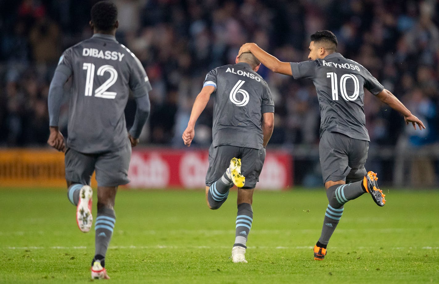 Minnesota United midfielder Emanuel Reynoso celebrates with midfielder Ozzie Alonso after Alonso scored the equalizer against Los Angeles FC