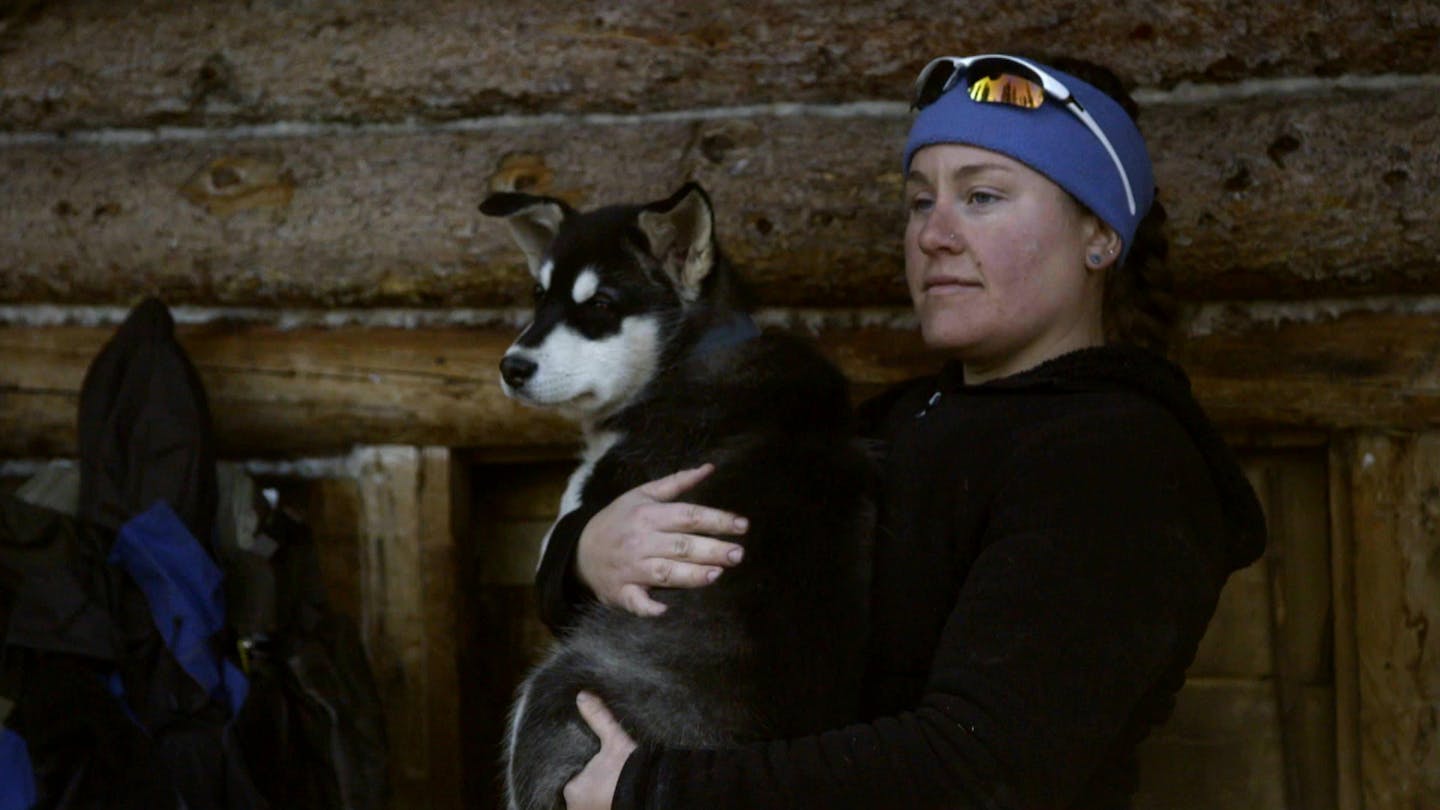 Ashley Selden, formerly of Lake Crystal, cradled one of her sled dogs, Gwen. She and her husband, Tyler, use a dog team in the Arctic National Wildlife Refuge.