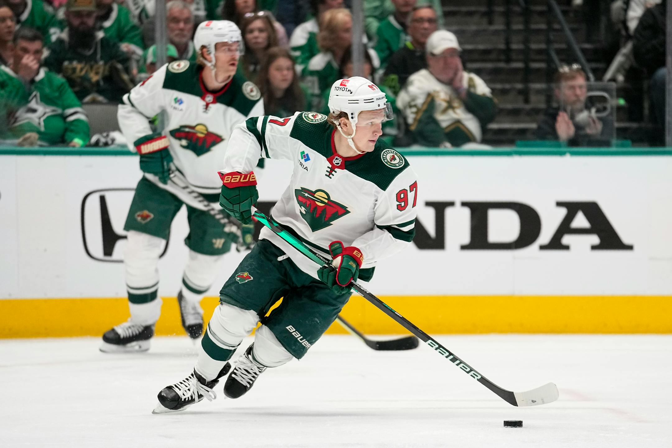 Minnesota Wild left wing Kirill Kaprizov moves the puck against the Dallas Stars during the first period of Game 1 of an NHL hockey Stanley Cup first-round playoff series, Monday night in Dallas.