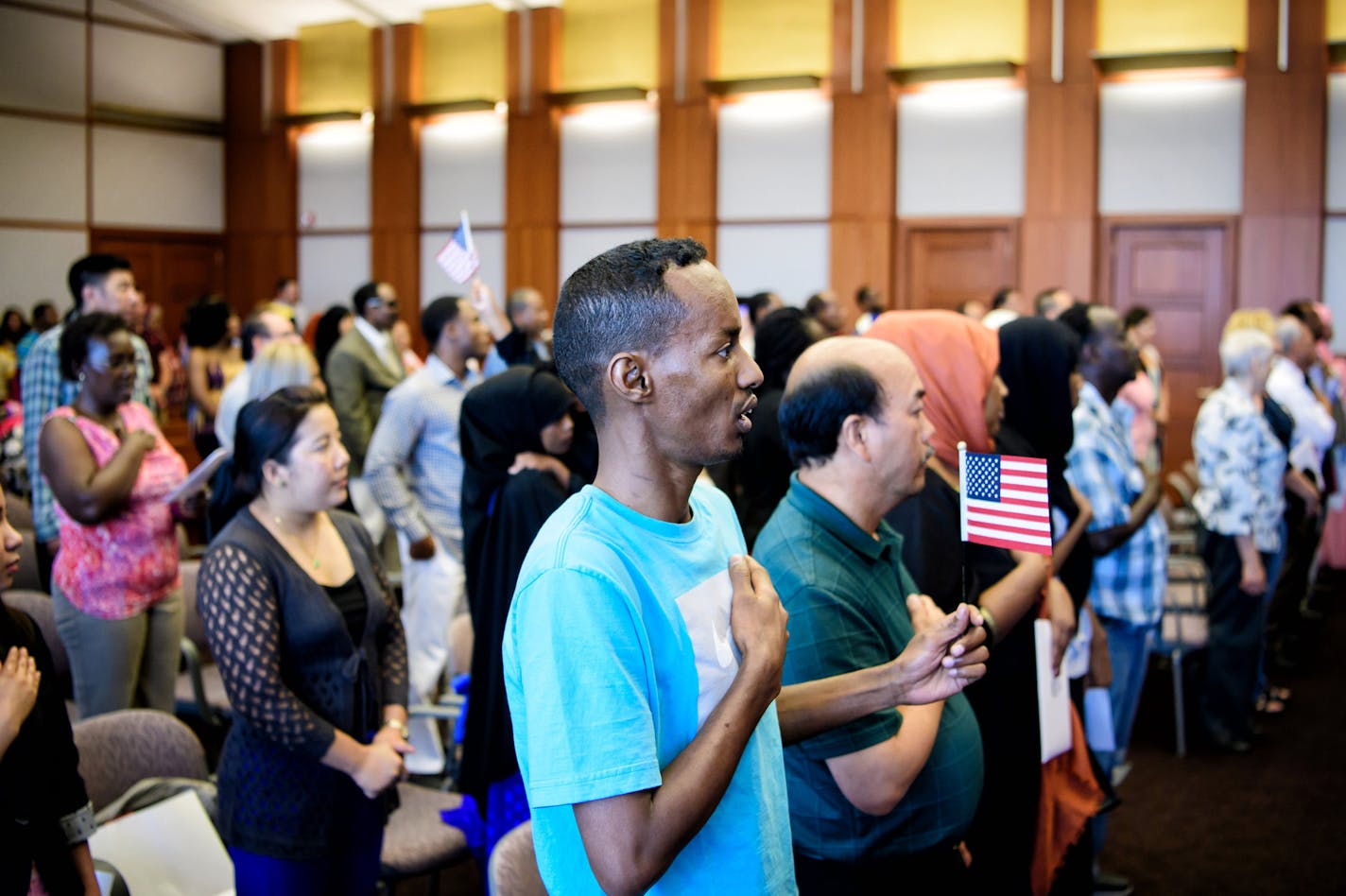 Farah Jama sang the Star Spangled Banner. He was among theapproximately 50 people from about 20 countries who became U.S. citizens. ] GLEN STUBBE * gstubbe@startribune.com Monday, June 20, 2016, Naturalization Ceremony in the U.S. District Court, Minneapolis where 55 people from 22 countries became U.S. citizens. The numbers of naturalization rates nationwide has been climbing this year compared to past years, causing some to think that a potential President Trump in the White House could have s