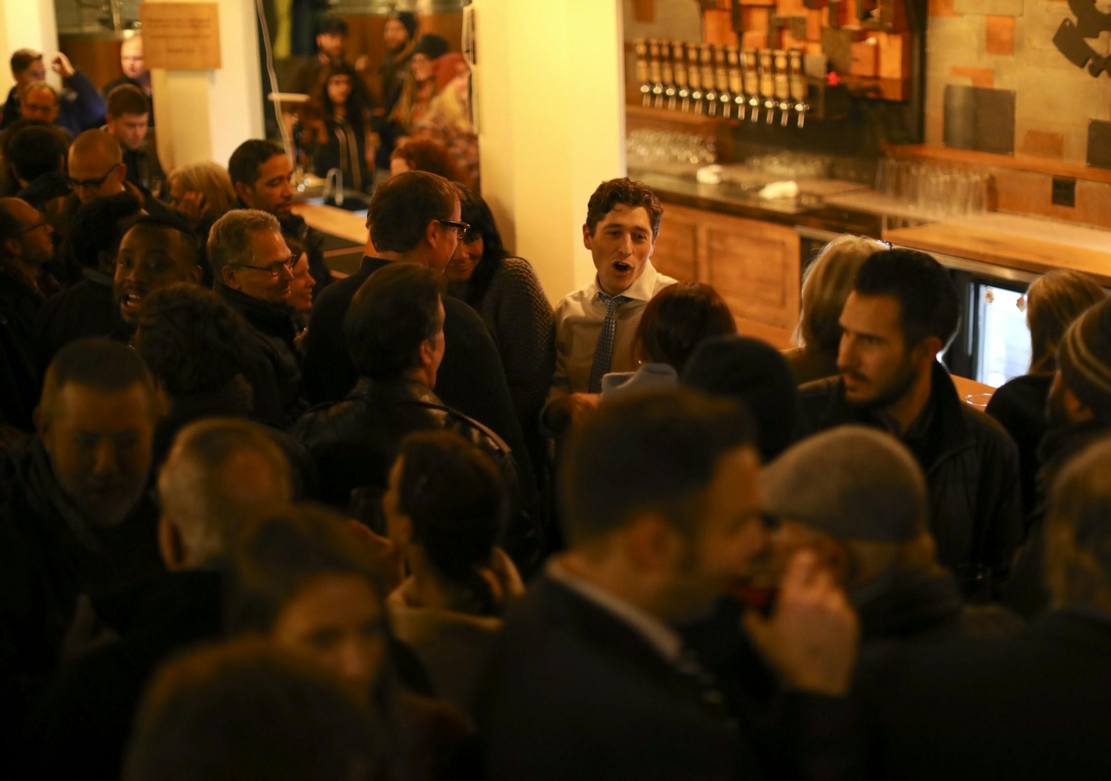 Jacob Frey, center in tie, mingled in a packed Dangerous Man Brewing Co. taproom moments after he announced that he was seeking the job of Mayor of Minneapolis.