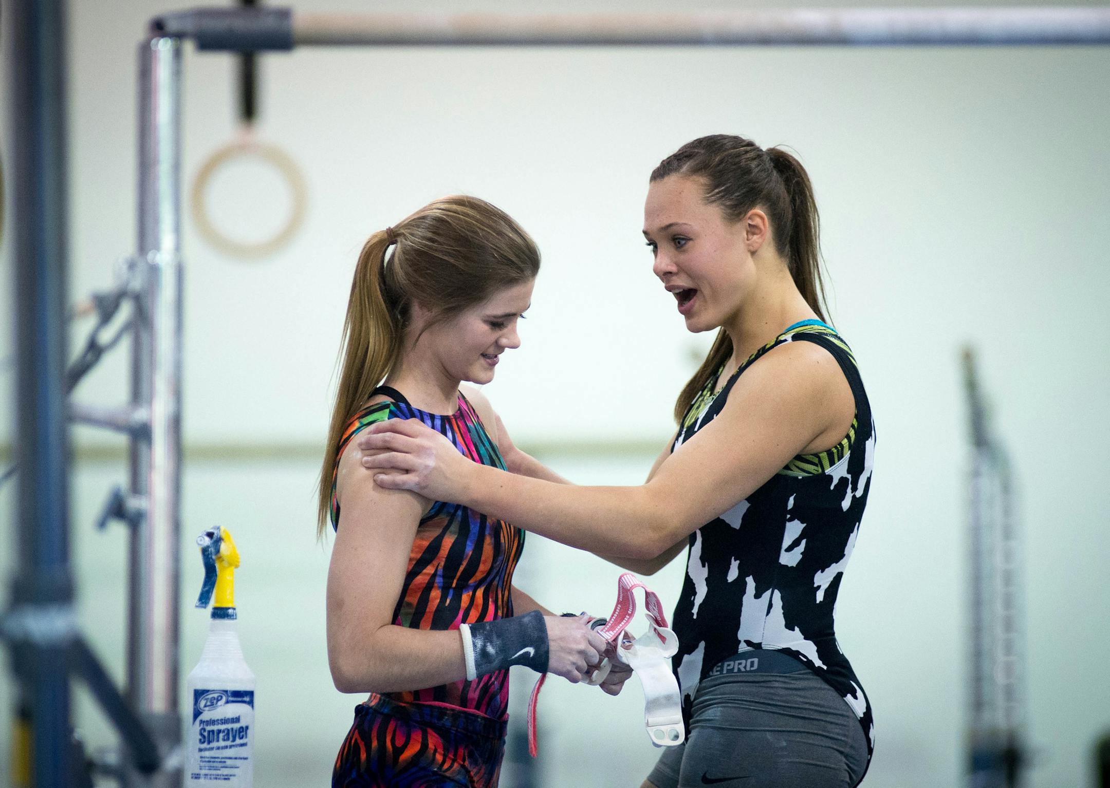 Northfield senior Christy Anderson, right, congratulates Bailey DuPay after DuPay's nice performance on the uneven bars during Saturday's meet. ] AARON LAVINSKY • aaron.lavinsky@startribune.com Northfield's gymnastics team holds an eight-team invitational at the Northfield Gymnastics Club Saturday, Dec. 6, 2014.