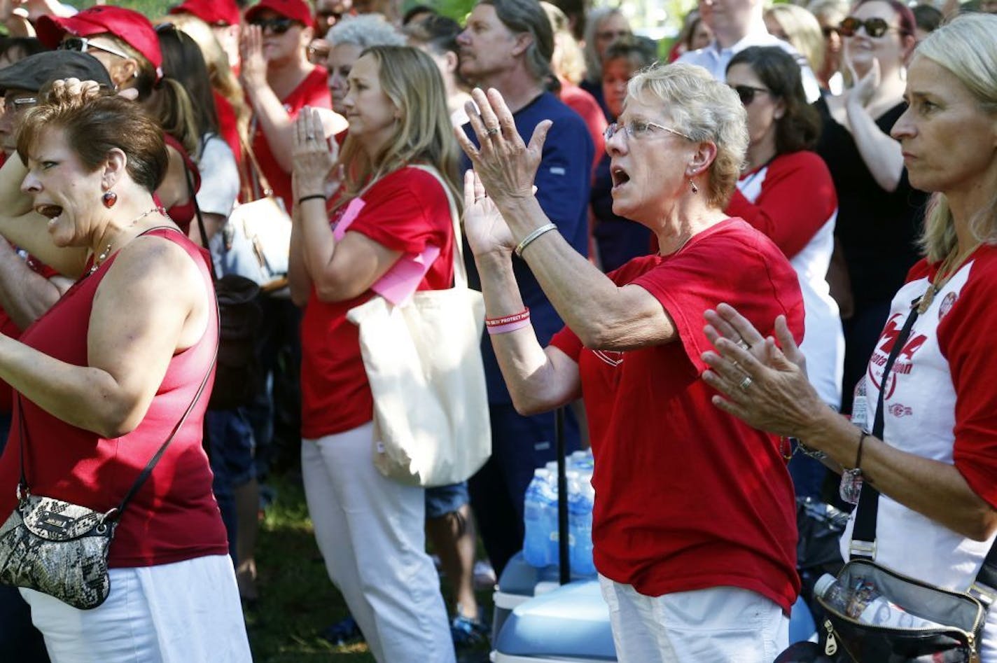 Members of the Minnesota Nurses Association applaud during a rally as community, labor leaders and faith-based groups gather at Stewart Park, Wednesday, Aug. 31, 2016 in Minneapolis to show support for Allina Health nurses who are scheduled to go on strike Monday, Sept. 5, unless a settlement is reached.