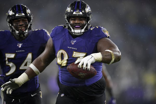 FILE - In this Sunday, Dec. 29, 2019 file photo, Baltimore Ravens defensive tackle Michael Pierce (97) celebrates his fumble recovery with linebacker 