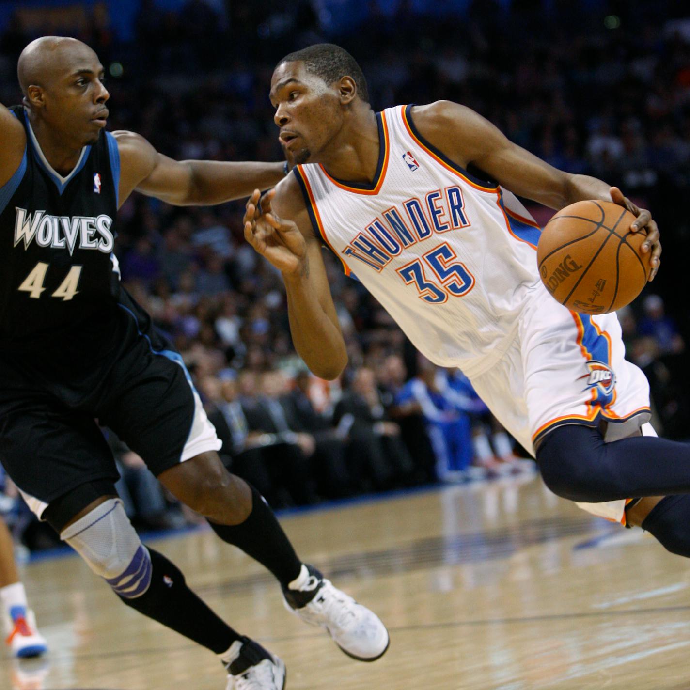 Oklahoma City Thunder forward Kevin Durant, right, drives around Minnesota Timberwolves forward Anthony Tolliver, left, in the third quarter of an NBA basketball game in Oklahoma City, Friday, March 25, 2011. Oklahoma City won 111 - 103. (AP Photo/Sue Ogrocki)