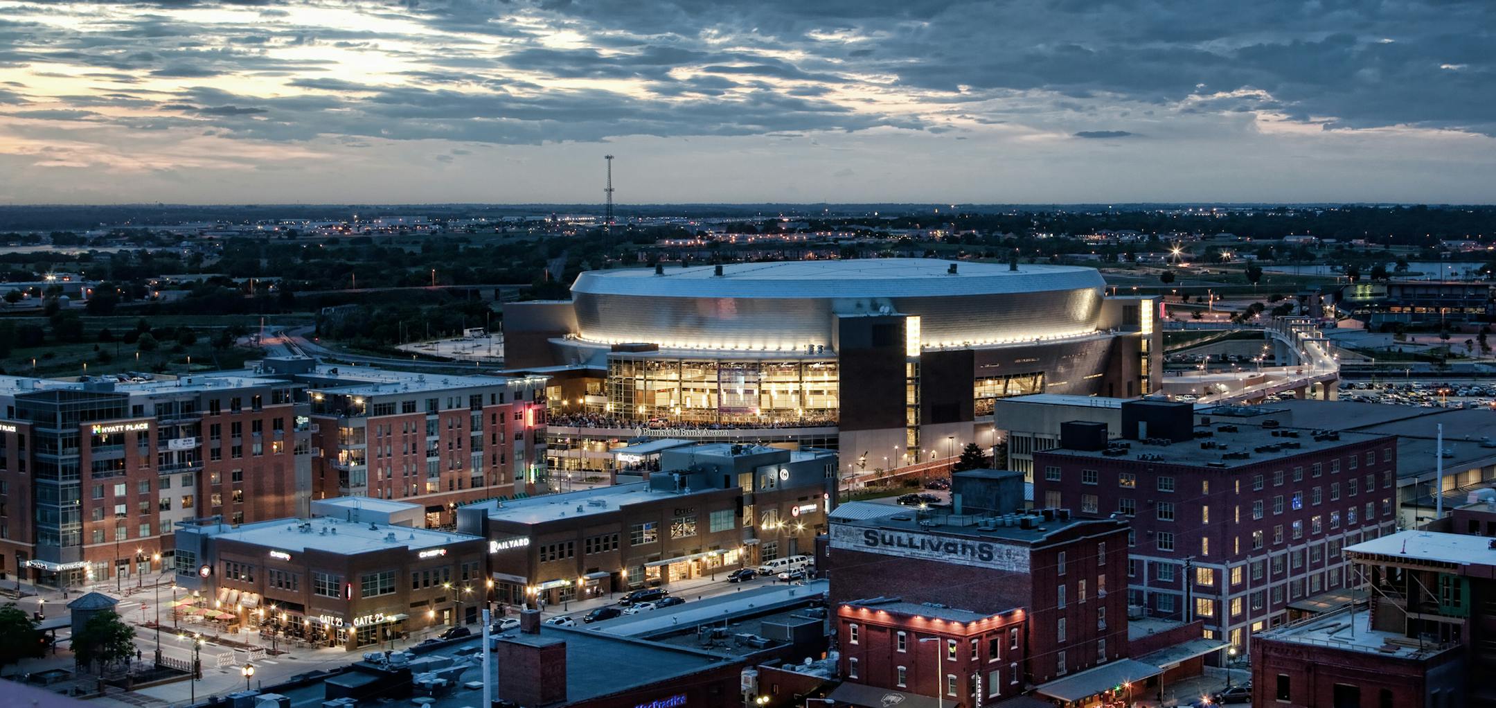 The skyline of the Haymarket district in Lincoln, Neb. Below, the piece “Iron Horse Legacy” near the Historic Haymarket water tower, appears to be chugging out of the wall.