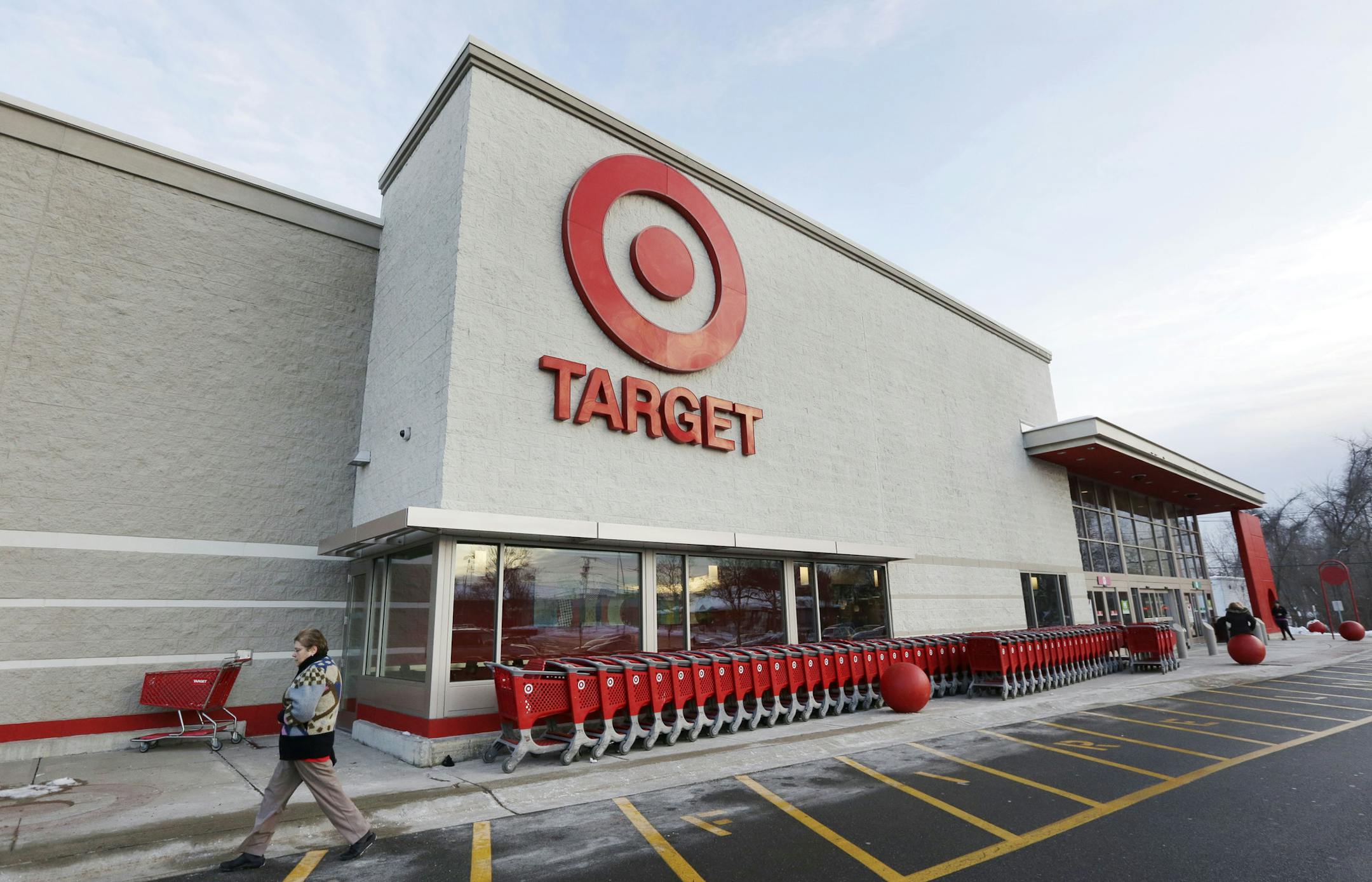 FILE - In this Dec. 19, 2013, file photo, a passer-by walks near an entrance to a Target retail store in Watertown, Mass. Target says that personal information &#xf3; including phone numbers and email and mailing addresses &#xf3; was stolen from as many as 70 million customers in its pre-Christmas data breach. That was substantially more customers than Target had previously said were affected. (AP Photo/Steven Senne, File) ORG XMIT: MIN2014011015142939