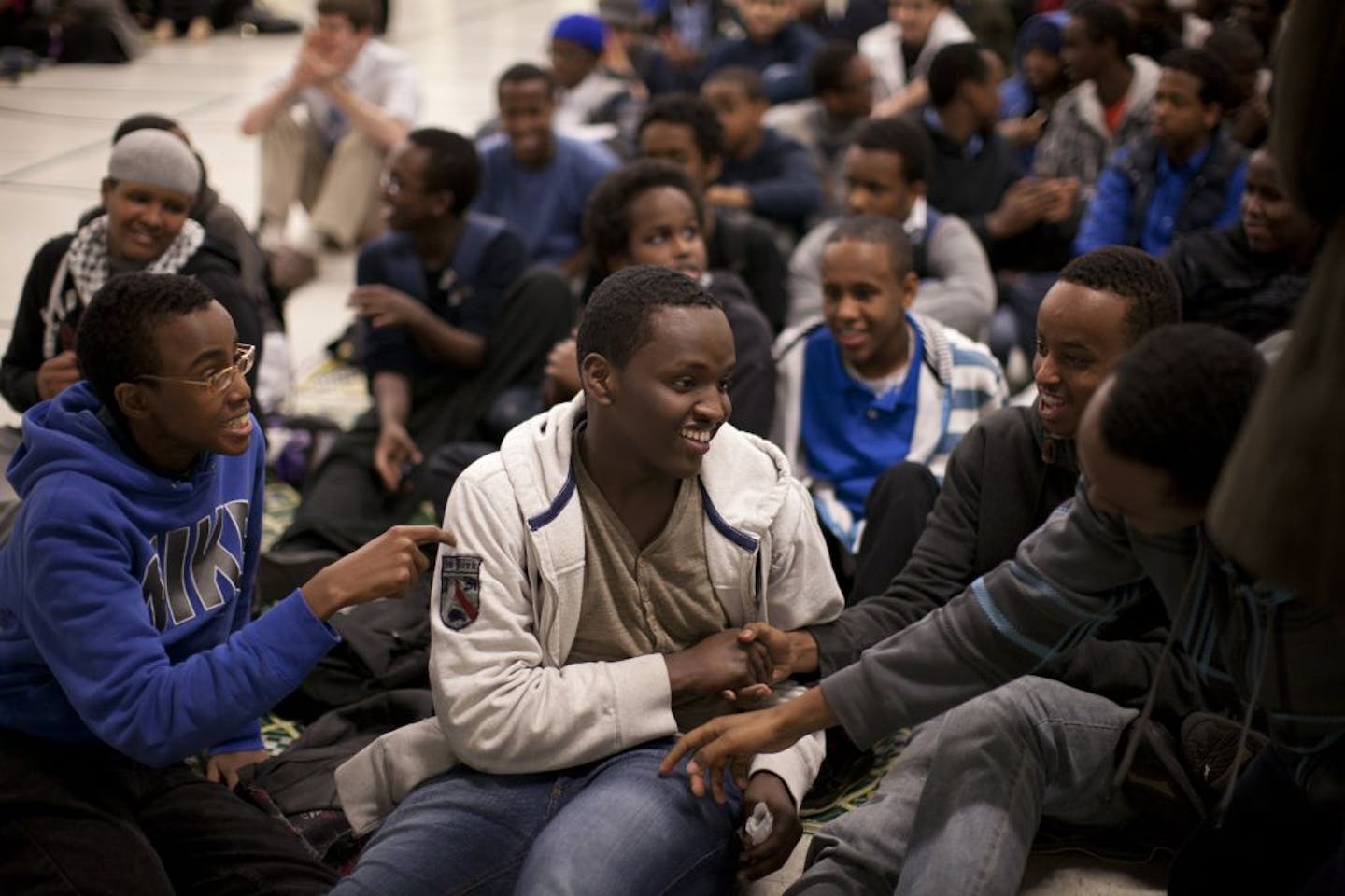 Ibrahim Adan, center, was congratulated by classmates after he took part in a spoken-word performance during an assembly at Ubah Medical Academy. Adan could be the next to join Poet Nation, a group of Somali-American poets.