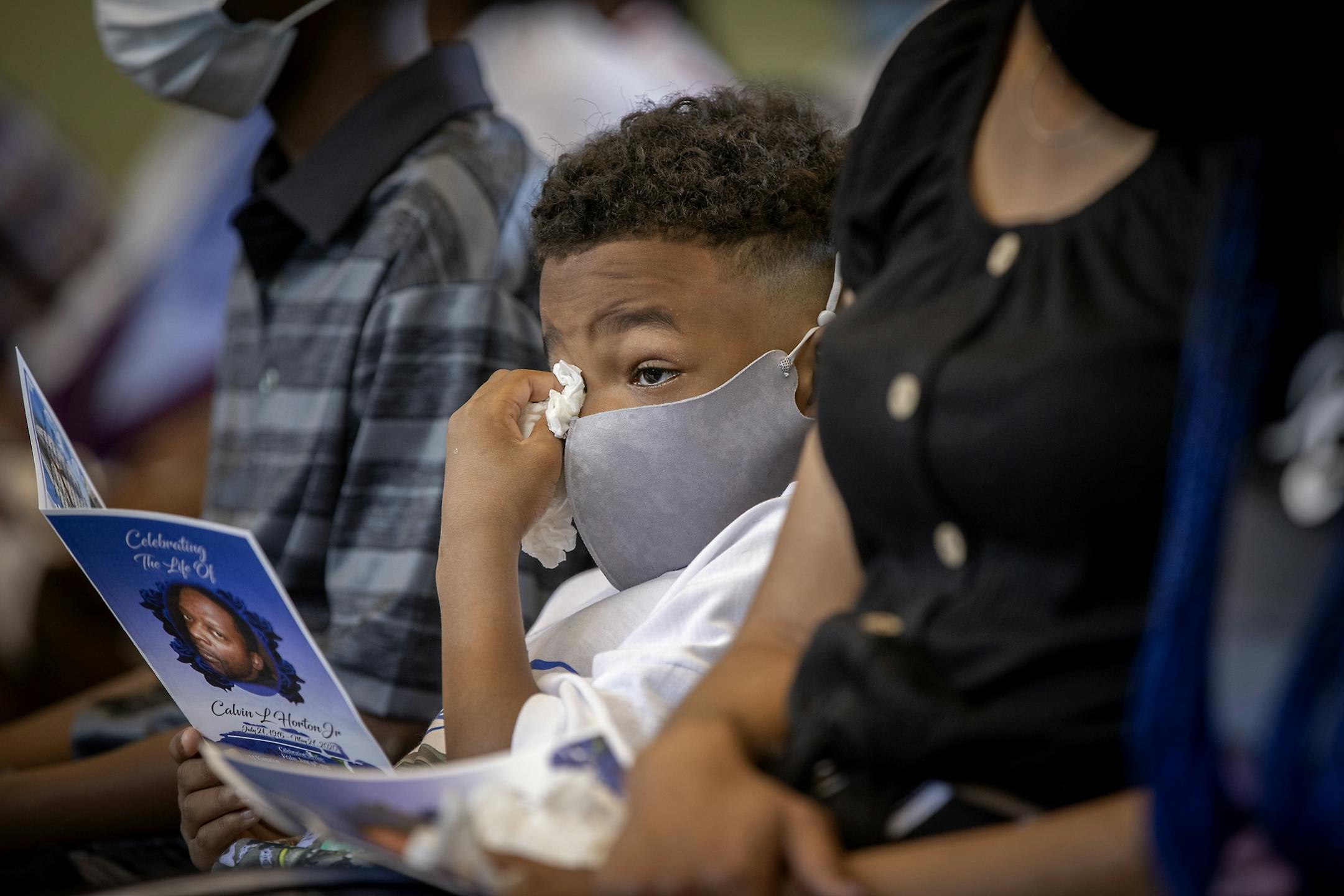 Calvon Horton, the twin son of Calvin L. Horton Jr. wiped away tears as he attended his father's funeral at Estes Funeral Chapel, Friday, June 19, 2020 in Minneapolis, MN. Horton was shot and killed by John Richard Rieple, a pawn broker. Police found Horton lying on the sidewalk in front of the shop near Bloomington and Lake on the second night of civil unrest in the aftermath of the killing of George Floyd at the hands of Minneapolis police.