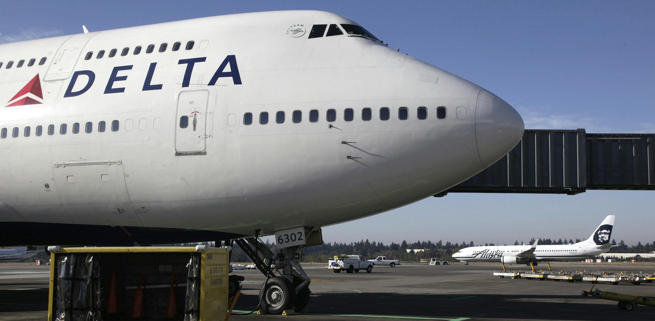FILE - In this Oct. 8, 2012 file photo, a Delta Air Lines airplane is parked at Seattle-Tacoma International Airport in Seattle.