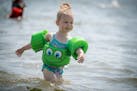 Adrielle Bedessem, 3, of Brooklyn Park showed her mother Delaine Bedessem how well she fared at swimming and keeping cool in a Lake Nokomis beach, Fri