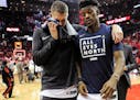Minnesota's Jimmy Butler, right, and Cole Aldrich walk off the court after the Wolves' 122-104 loss to the Rockets in Game 5