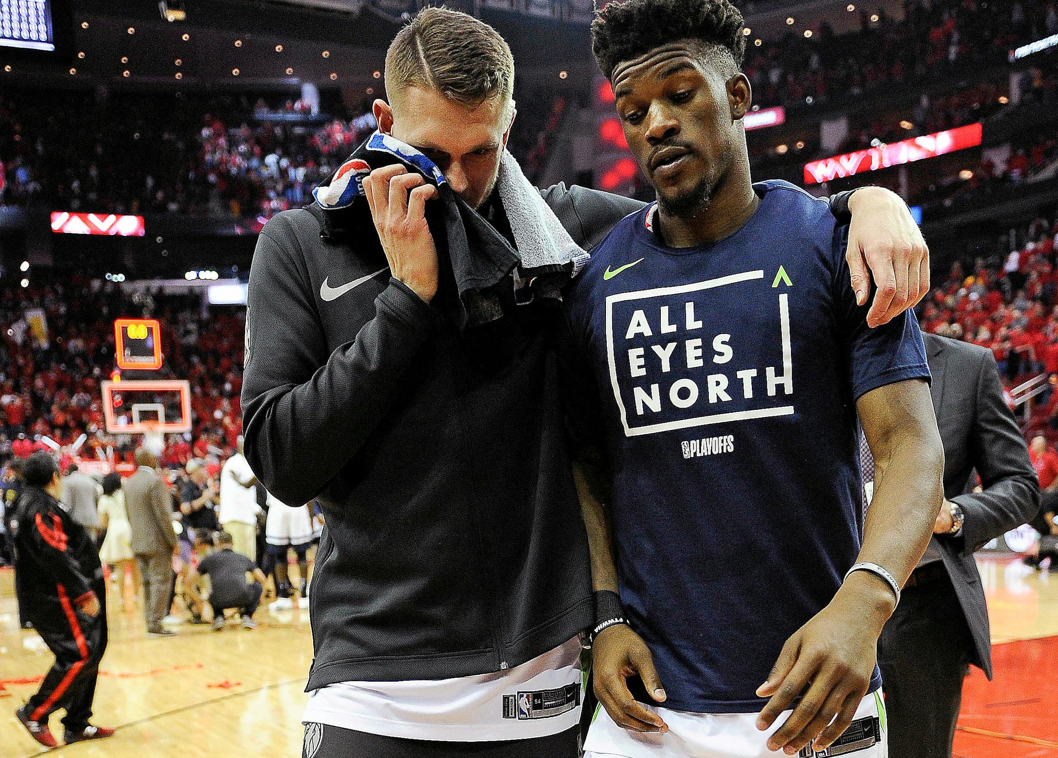 Minnesota's Jimmy Butler, right, and Cole Aldrich walk off the court after the Wolves' 122-104 loss to the Rockets in Game 5