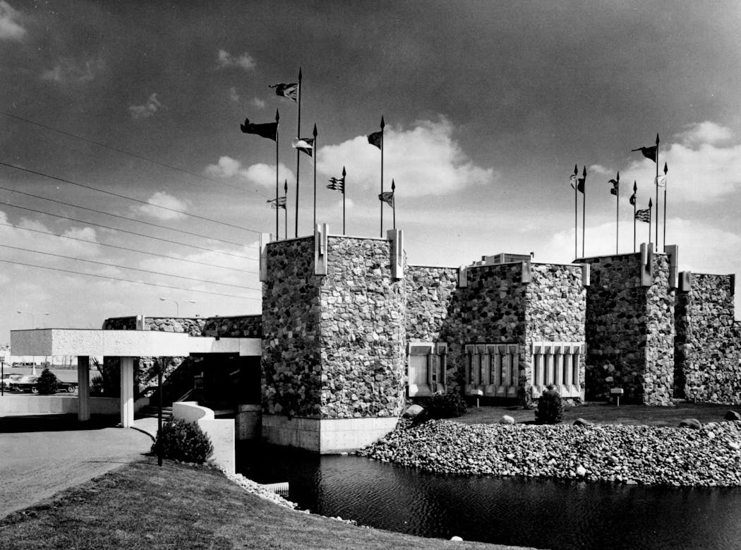 Moat, banners, drawbridge and towers create a colorful, twentieth century version of King Arthur’s headquarters for the Twin Cities’ colorful Camelot restaurant.
