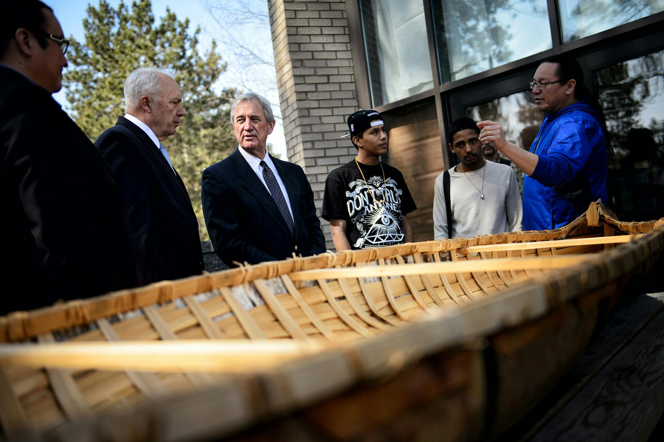 Rep. John Kline and Rep. Rick Nolan looked over a birch bark canoe being constructed at the school.