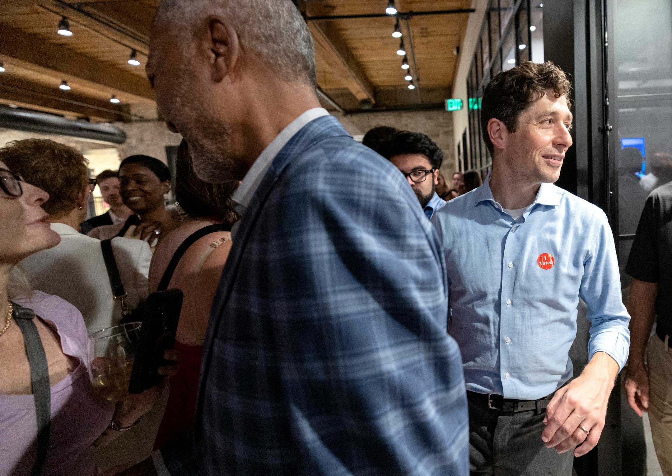 Minneapolis mayor Jacob Frey passes Don Samuels during a primary election night watch party.
