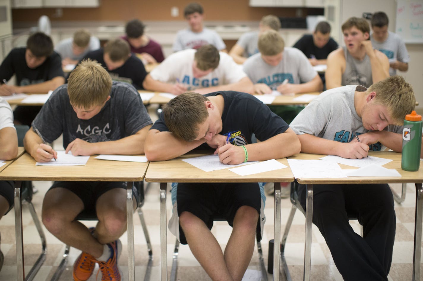 Football player from the left; Cullen Hoffmann, Tanner Fester and Kolt Soine worked intensely on a letter of appreciation to their parents during part practice at Atwater-Cosmos-Grove High School in Grove City, Minn., on Monday October 5, 2015. ] RENEE JONES SCHNEIDER &#x2022; reneejones@startribune.com The coach of the Atwater-Cosmos-Grove City football team in central MN is focusing on more than Xs and Os. He's taking his team through some unusual non-athletic exercises to help them become res