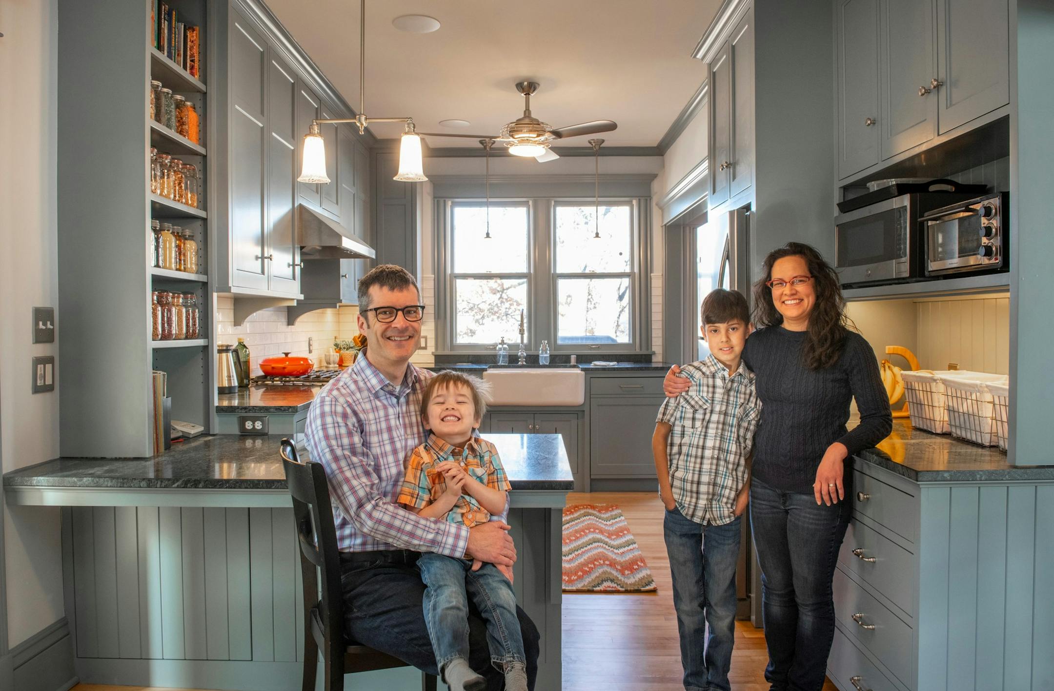 Nathan Lockwood, Malcolm Lockwood, 3, Ian Lockwood, 9, and Daisy Cross in their new kitchen in NE Mpls. house on MSP home tour
