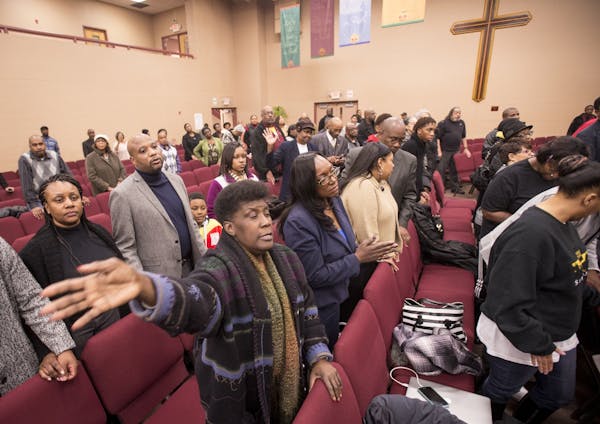 Churchgoers took part in a closing prayer recognizing police officers during Wednesday night's service at Fellowship Missionary Baptist Church.