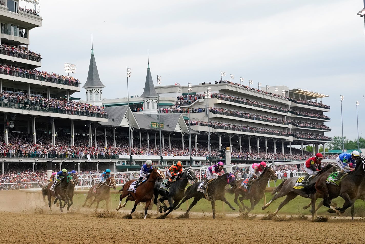 Javier Castellano, atop Mage, third from left, is seen behind with others behind the pack as they make the first turn while competing in the 149th running of the Kentucky Derby horse race at Churchill Downs Saturday, May 6, 2023, in Louisville, Ky. (AP Photo/Julio Cortez)