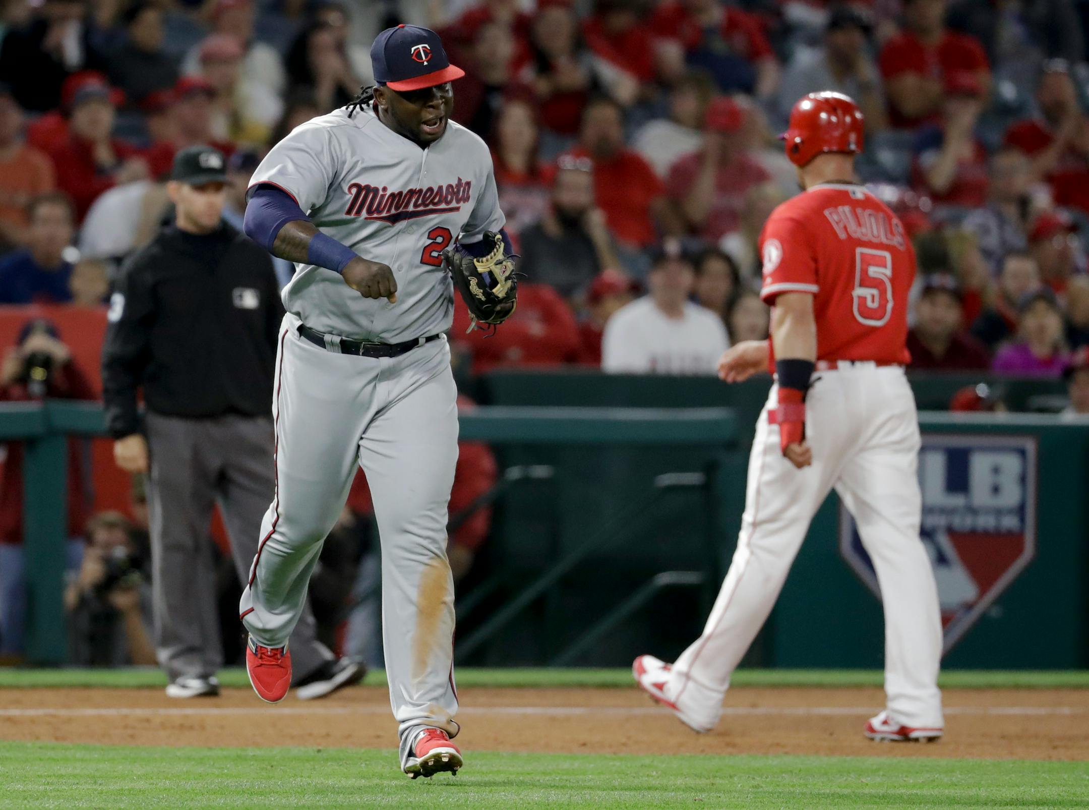 Minnesota Twins third baseman Miguel Sano, left, celebrates after the final out of the fourth inning against the Los Angeles Angels during a baseball game in Anaheim, Calif., Thursday, June 1, 2017. (AP Photo/Chris Carlson)