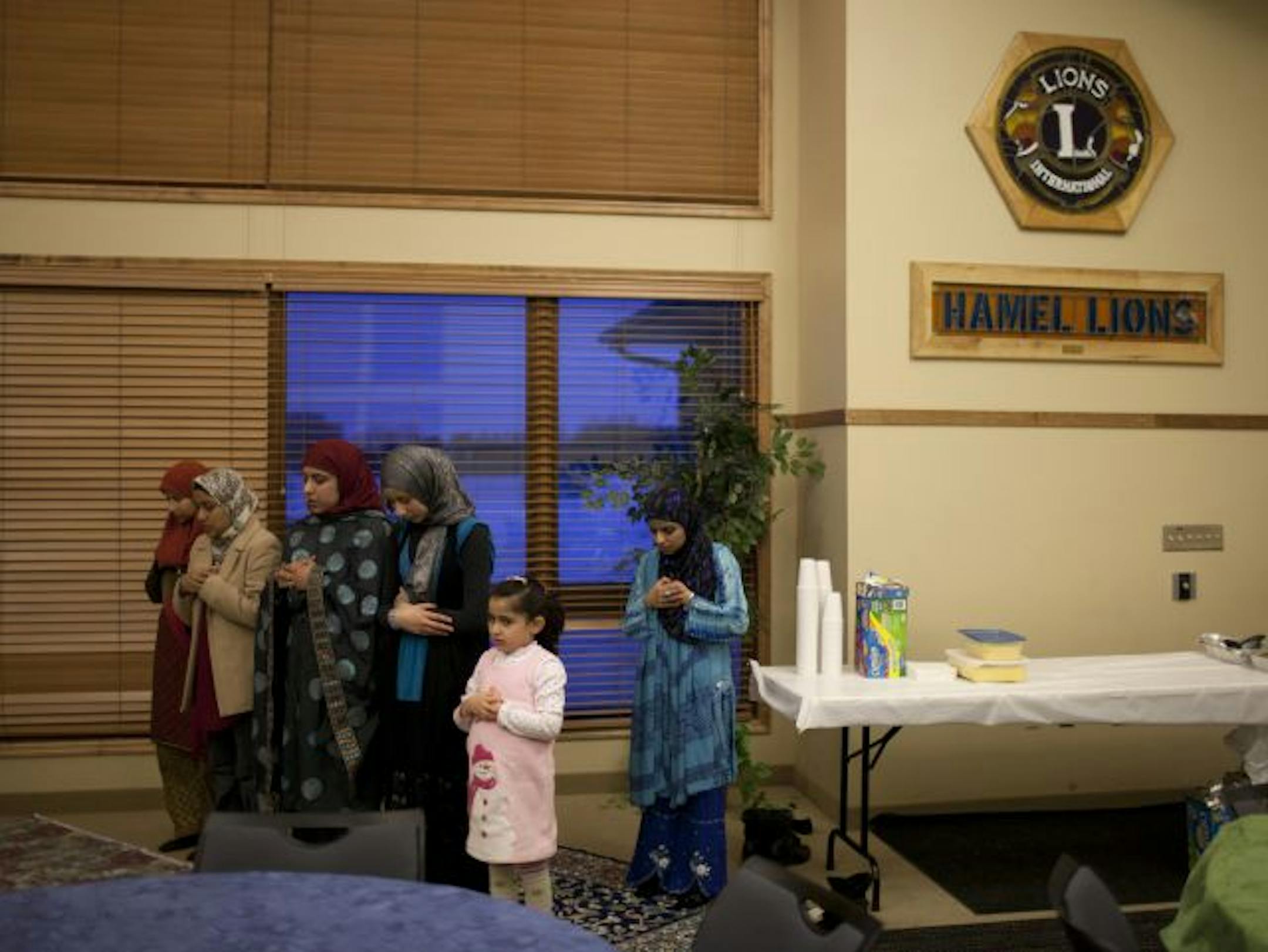 The women of Northwest Islamic Community Center prayed during a recent Friday Family Fun Night in the Medina building.