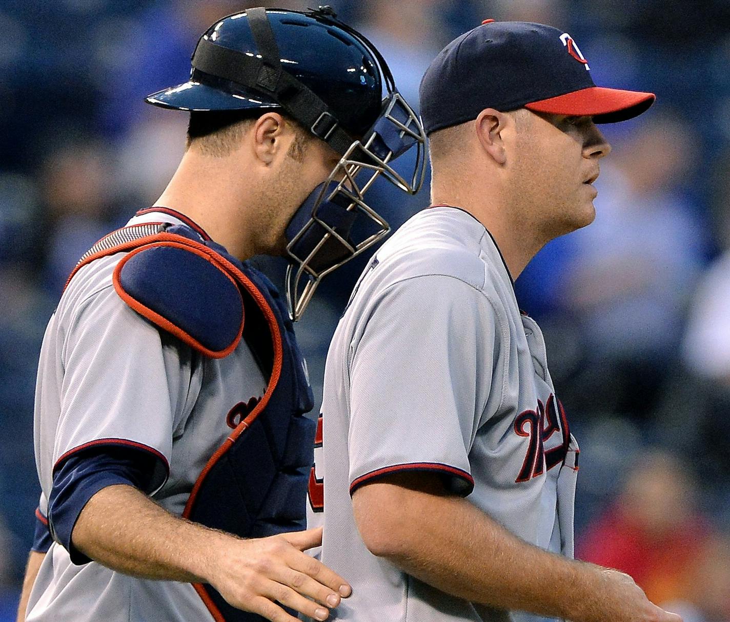 Minnesota Twins catcher Joe Mauer (7) walks starting pitcher P.J. Walters (39) back to the mound in the first inning after giving up a single to Kansas City Royals' Lorenzo Cain during Wednesday's baseball game on June 5, 2013, at Kauffman Stadium in Kansas City, Missouri. (John Sleezer/Kansas City Star/MCT)