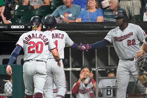 The Twins celebrate after Jorge Polanco’s home run Wednesday night.