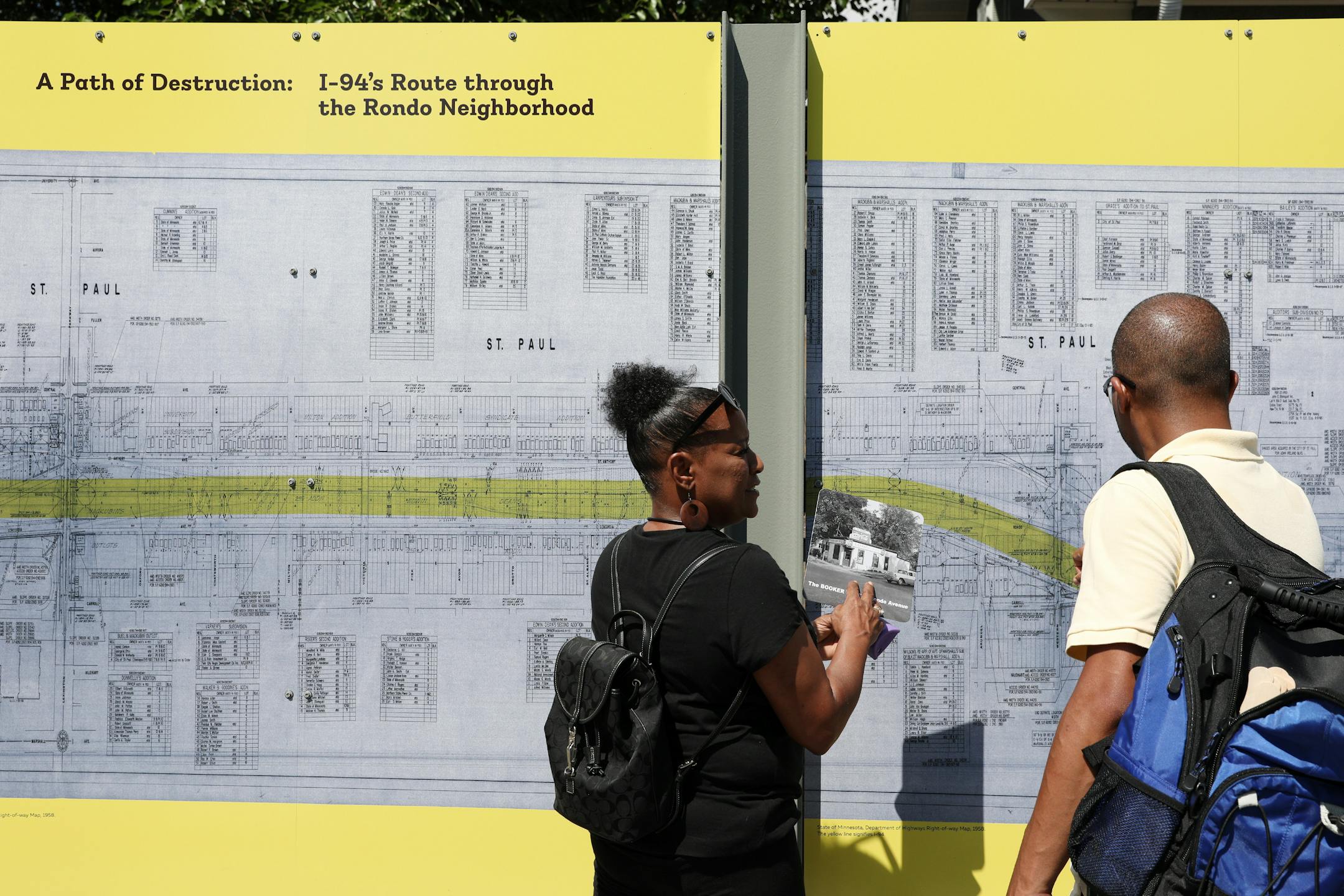 Frances and Jeremiah Ellis looked for the address of great, great, grandparents Mattie and Mance Ellis who owned The Booker T at 381 Rondo Avenue on a board explaining how the construction of I-94 destroyed the Rondo neighborhood. ] ANTHONY SOUFFLE • anthony.souffle@startribune.com Officials held a grand opening for the Rondo Commemorative Plaza Saturday, July 14, 2018 in St. Paul, Minn.