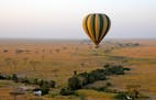 A hot air balloon floats above the Seronera River in Serengeti National Park, a UNESCO World Heritage Site in Tanzania.