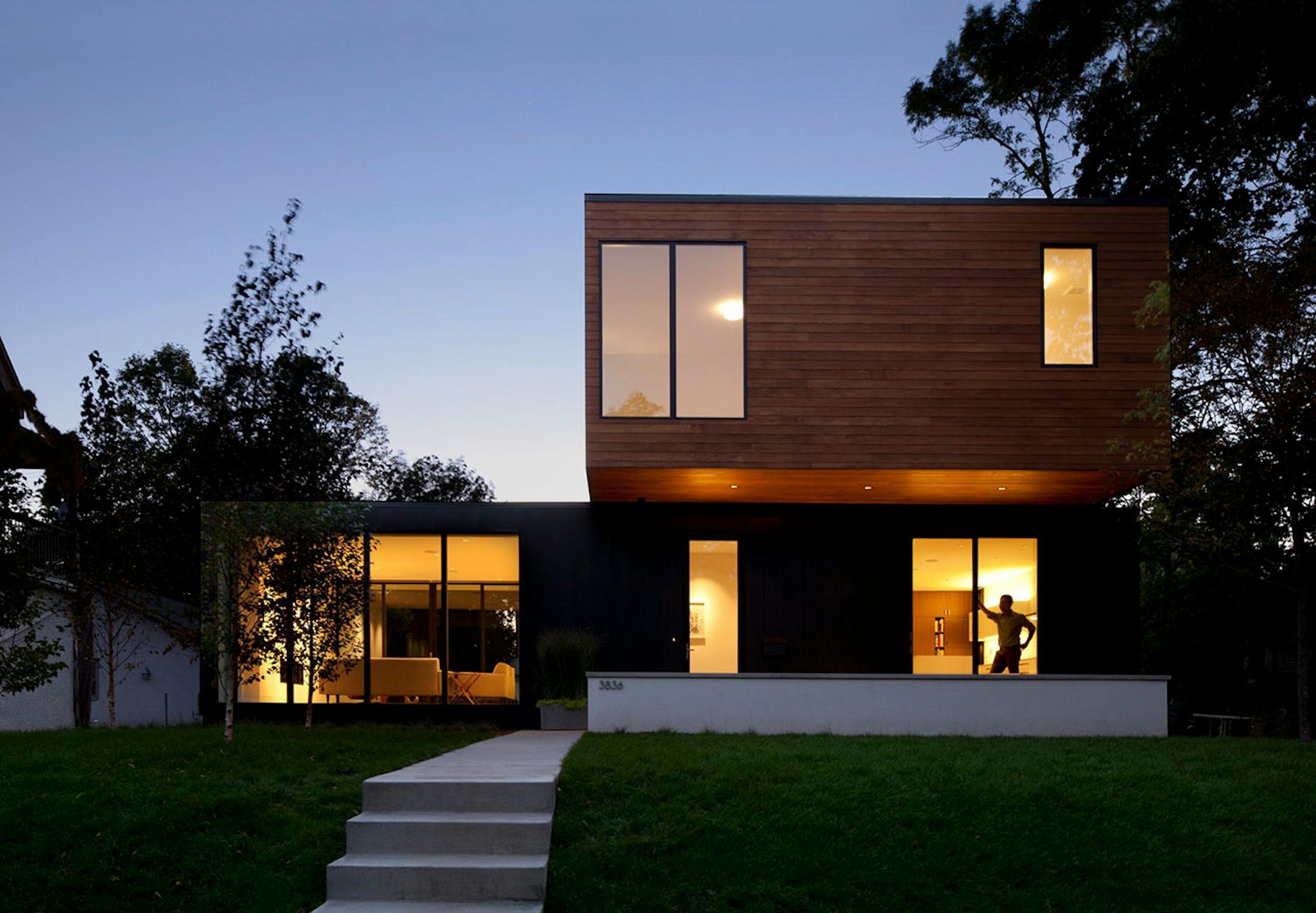 The design is composed of overlapping boxes, which create an L-shaped floor plan and modern front porch.