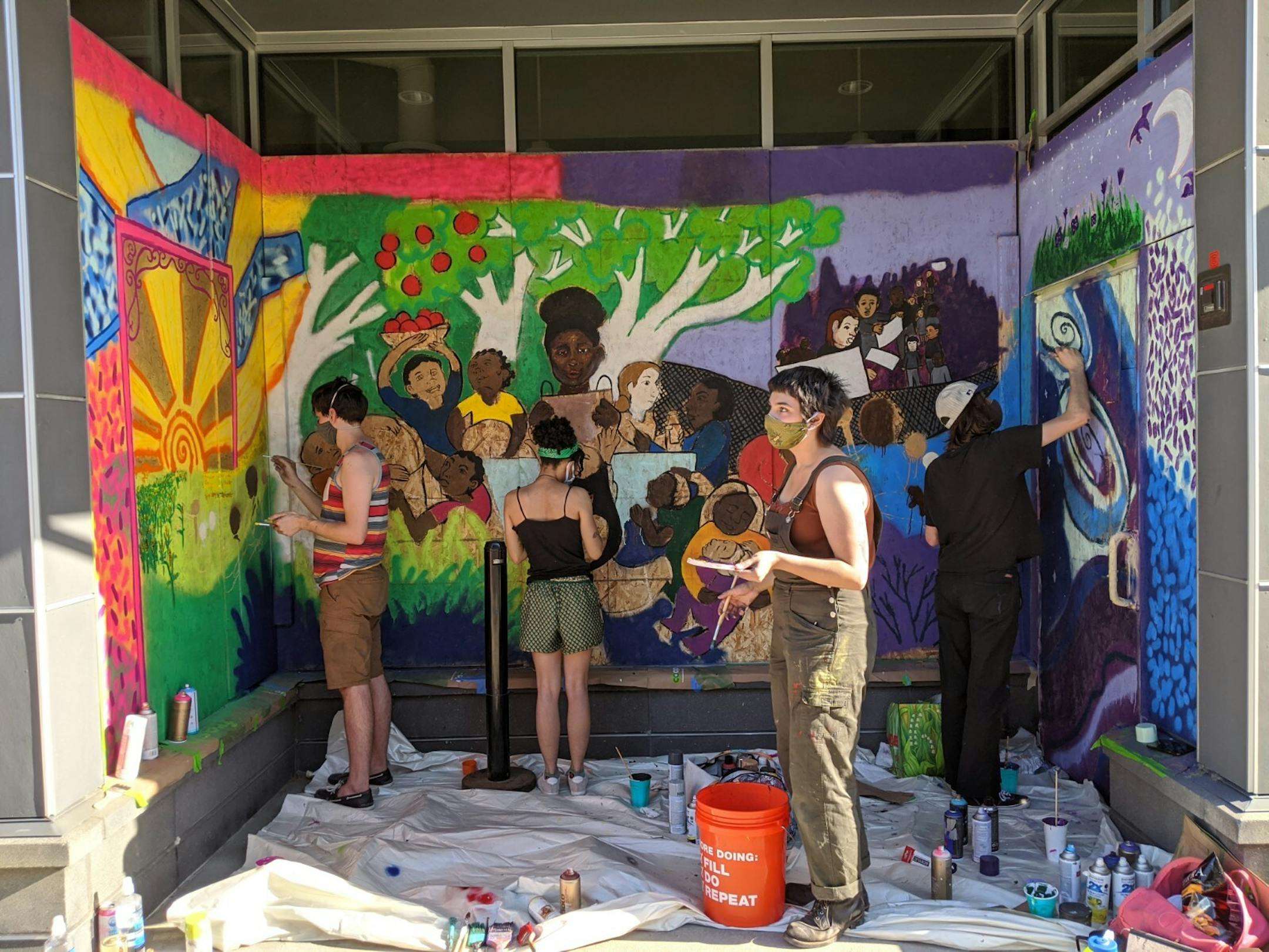 Artists Andrew Hinrichs, Simone Alexa, and Jack Long painted a three-panel mural celebrating community, protest and nature at Seward Co-op (317 E. 38th St.) as a way to express themselves following the death of George Floyd by Minneapolis police.