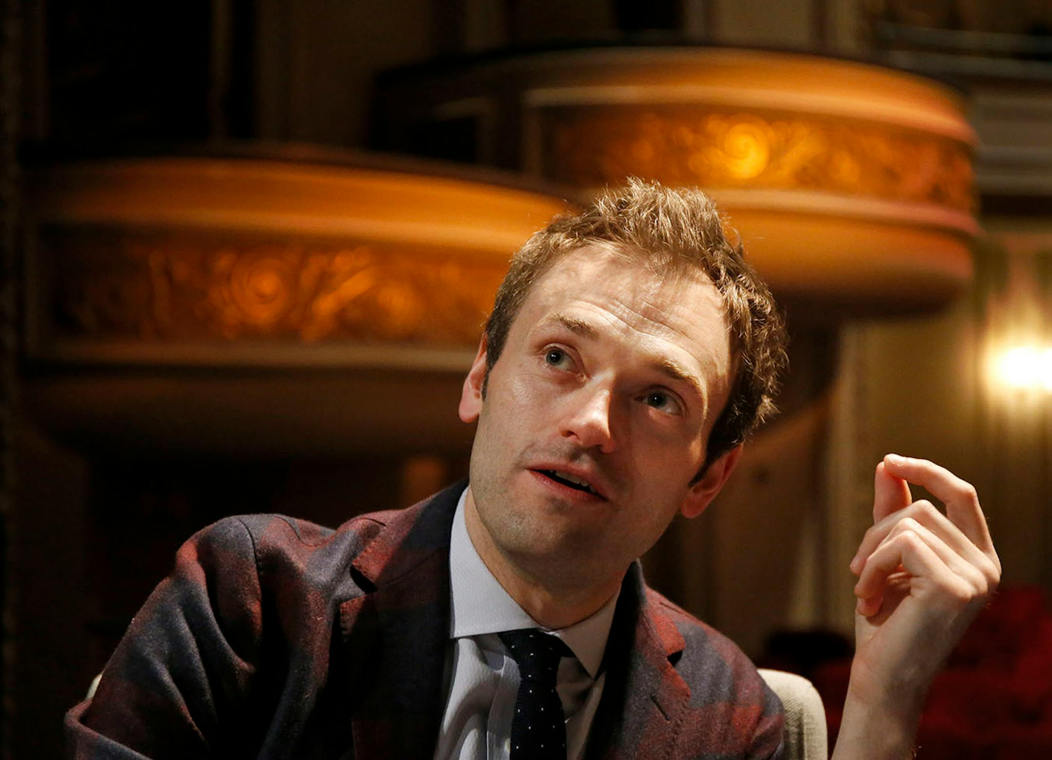 In this April 5, 2016 photo, Chris Thile speaks during an interview at the Fitzgerald Theater in St. Paul, Minn. Thile will replace Garrison Keillor as host of "A Prairie Home Companion," the popular public radio variety show, after Keillor retires this summer. Thile starts hosting a 13-episode run of the show in October.