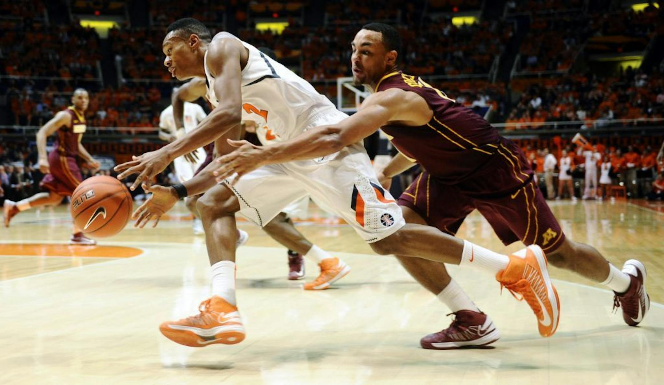 Illinois guard Joseph Bertrand drives under pressure from Minnesota guard Joe Coleman