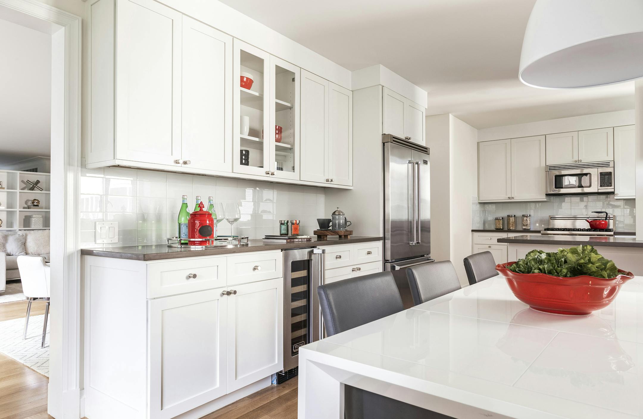 Hints of red helps to break up the color of this otherwise monochromatic kitchen. (Design Recipes/TNS)