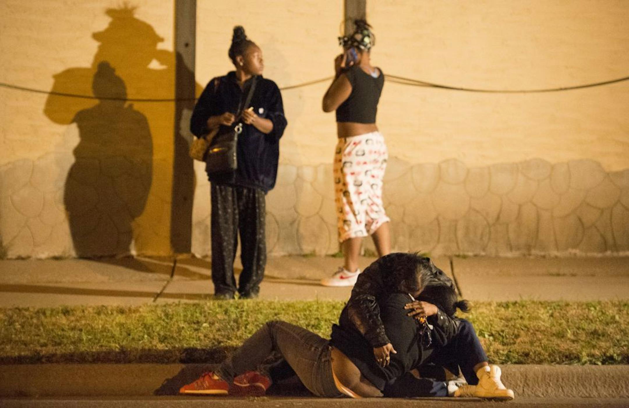 Two young women comforted each other on the street after a fatal shooting took place near Earl Street and York Avenue in St. Paul.